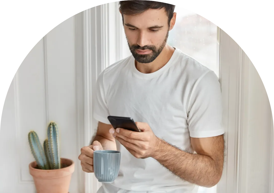 A hand holding a magnifying glass over white tiles spelling out the word 'FRAUD' on a white background. The magnifying glass enlarges the letter 'F' in the word.