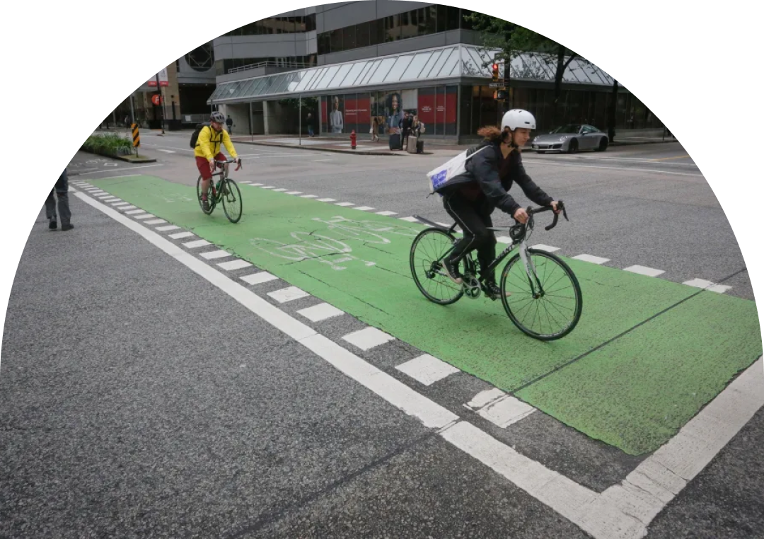 A small green plant with two leaves grows out of a glass jar filled with assorted coins. The background is blurred with soft, natural light, focusing attention on the plant and the jar.