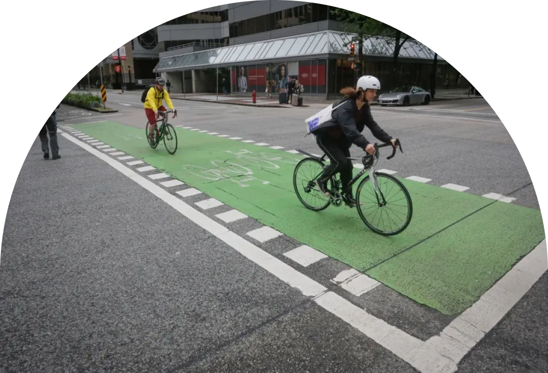 A small green plant with two leaves grows out of a glass jar filled with assorted coins. The background is blurred with soft, natural light, focusing attention on the plant and the jar.