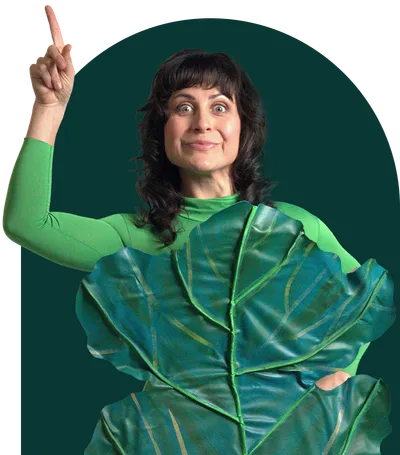 A woman smiling while holding a phone.